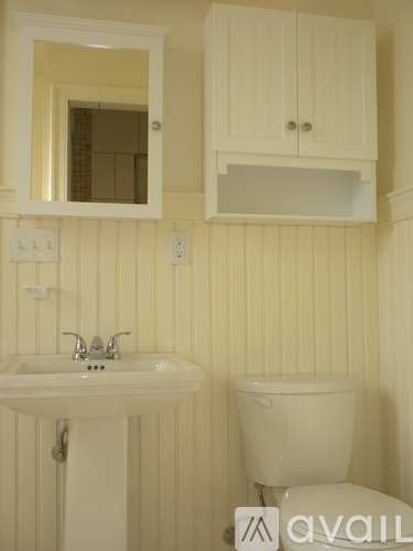 A bathroom with a sink, toilet and medicine cabinet.