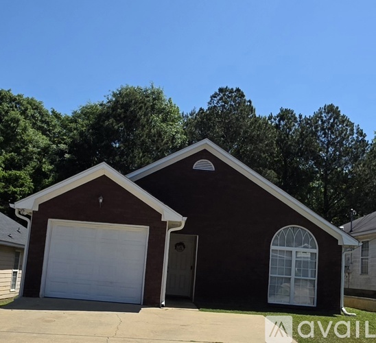 A house with a garage and a window is available for sale.