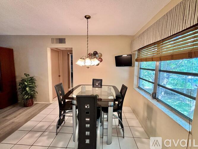 A dining room with a table set for four.
