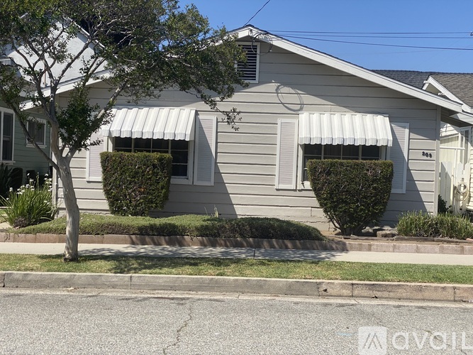 A house with a tree in front of it.