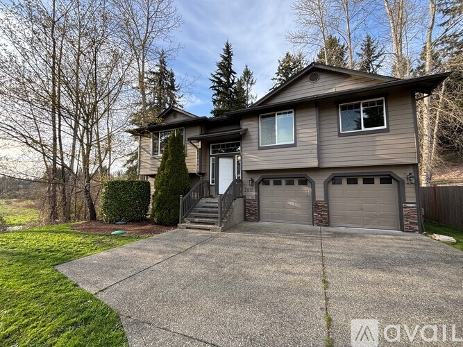 A house with a grey garage door is for sale.