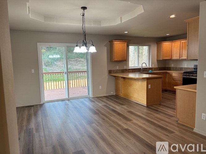 A kitchen with wooden cabinets and a large island.