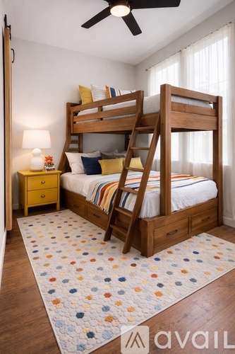 A bedroom with a bunk bed and a ceiling fan.