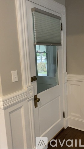 A white door with a window and a handle.