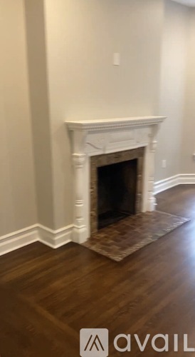 A fireplace in a room with wooden flooring.
