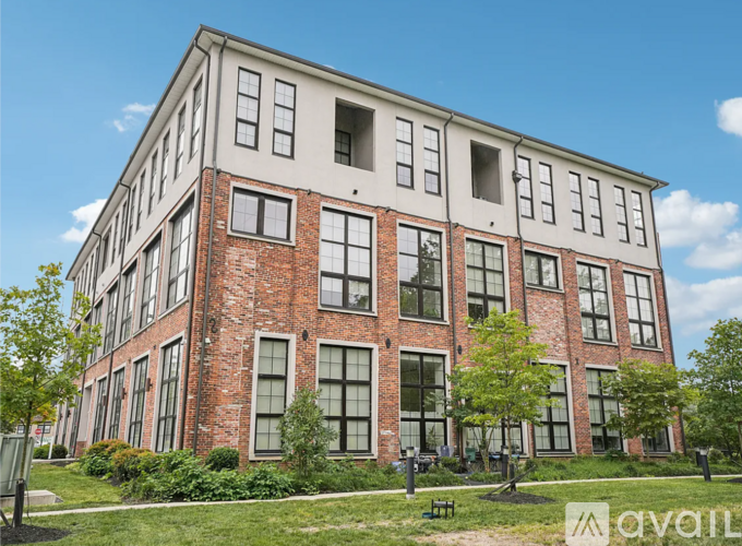 A large red brick building with a white trim around the windows and roofline.