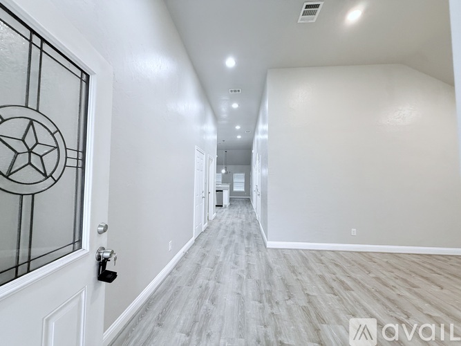 A long hallway with a door on the left and a lock on the door.