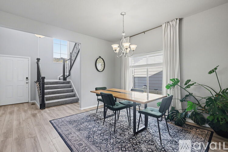 A dining room with a table and chairs.