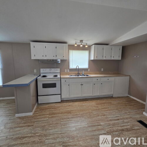A kitchen with a white oven and cabinets.