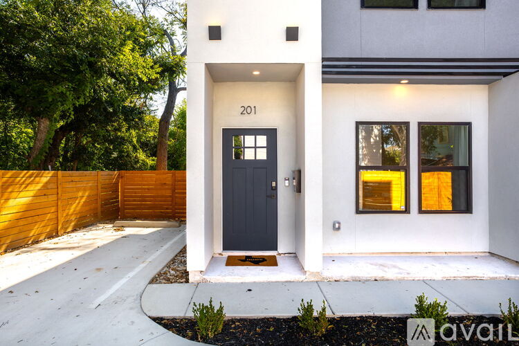 A modern house with a black door and windows.