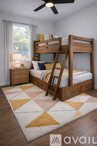 A bedroom with a bunk bed and a rug on the floor.