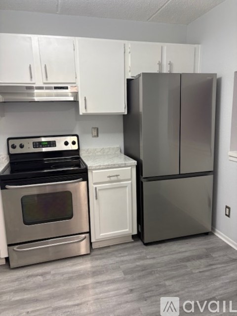 A kitchen with a stove, oven, and refrigerator.