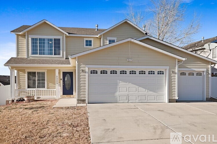 A two-story house with a garage is available for sale.