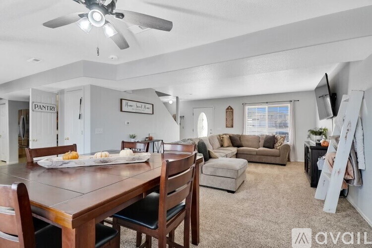 A dining room with a wooden table and chairs.