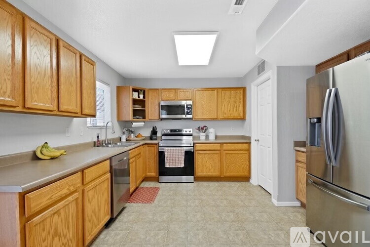 A kitchen with wooden cabinets and a white refrigerator.