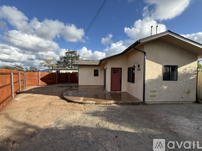 A house with a red door is available for rent.