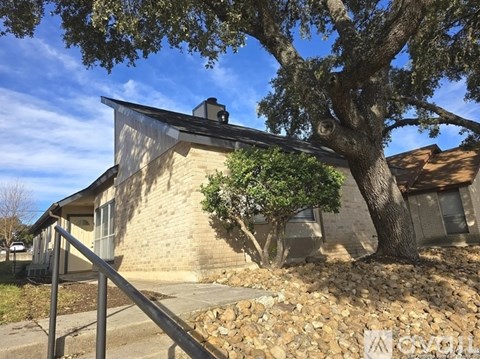 A house with a tree in front of it.