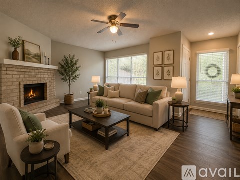 A living room with a fireplace and wood flooring.