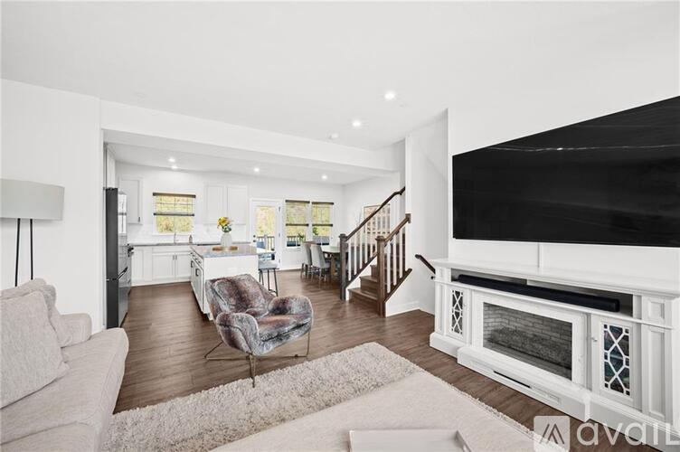 A living room with a white couch and a grey chair.