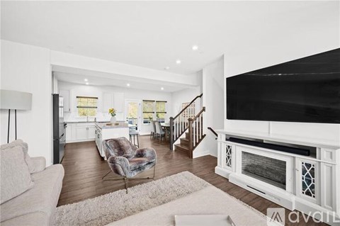 A living room with a white couch and a grey chair.
