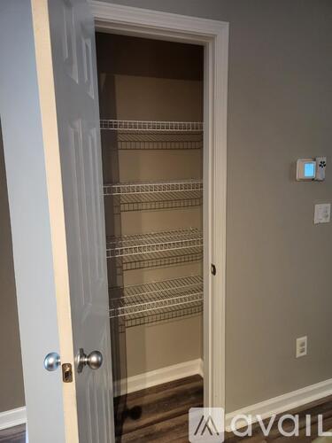 A white door with a silver handle and a glass panel with a shelf.