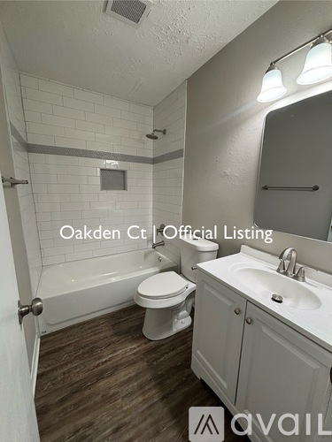 A bathroom with a toilet, sink, and mirror.