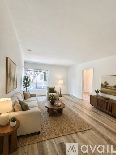 A living room with a couch, a coffee table, and a rug.