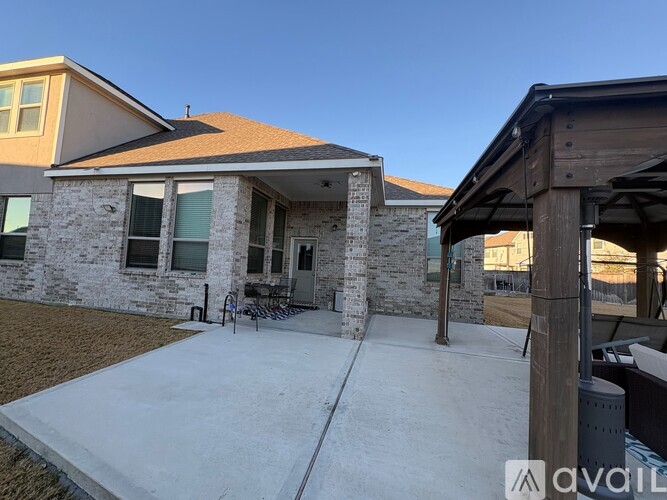 A house with a covered patio area is available for rent.