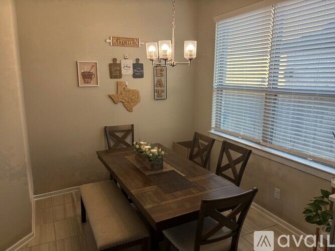A kitchen with a wooden table and chairs.