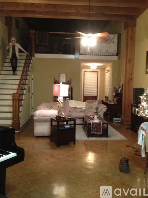 A living room with a piano and a couch.