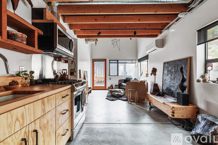 A kitchen with wooden cabinets and a stove top oven.