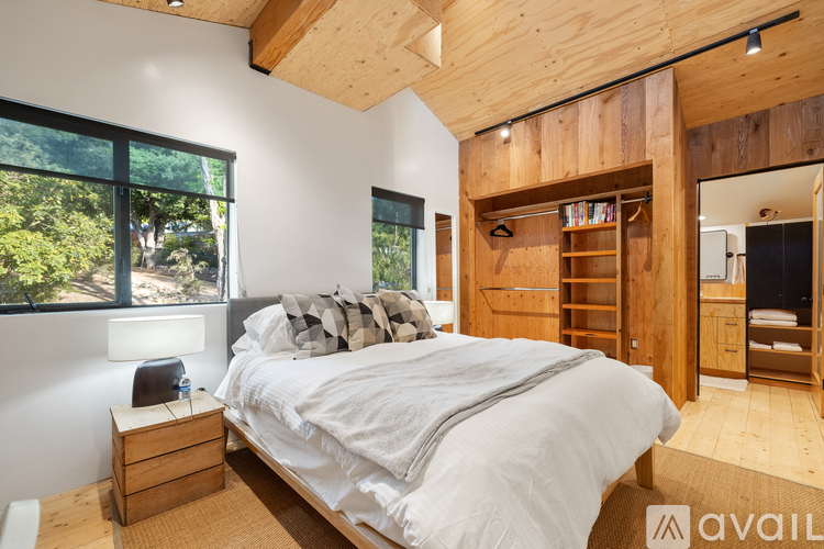 A bedroom with a large bed and a wooden headboard.
