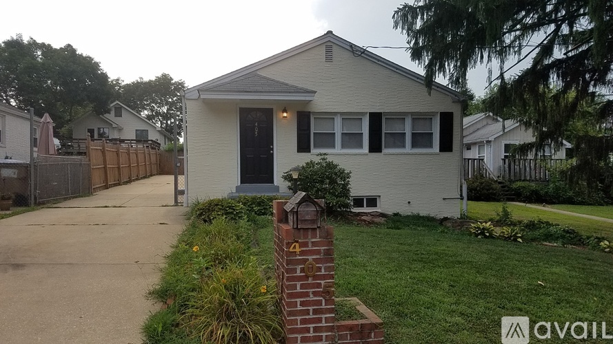 A house with a brick pillar in front of it.