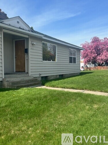 A house with a brown door and a small porch.