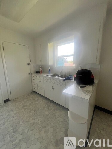 A bathroom with a white vanity and a window.