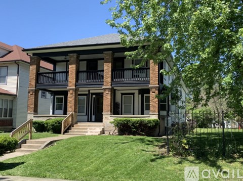 A house with a balcony and a front door is for sale.
