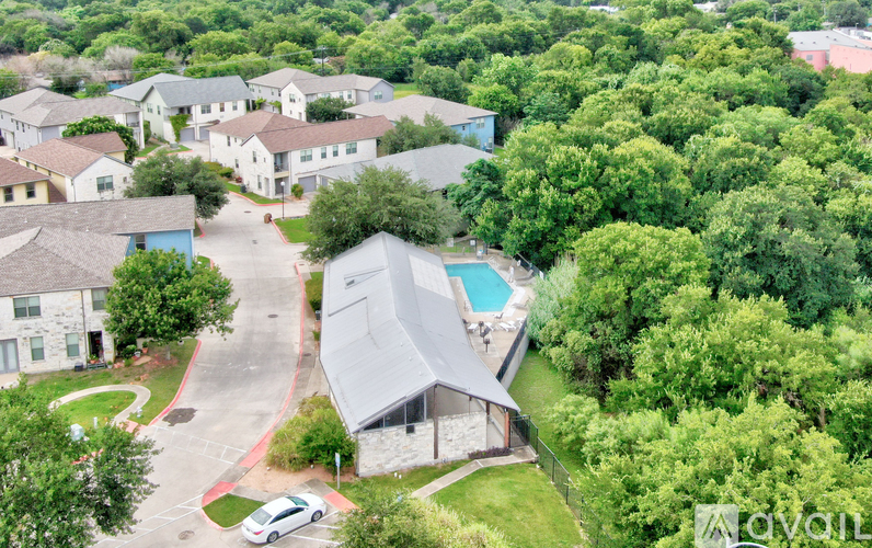 A bird's eye view of a residential area with a swimming pool.