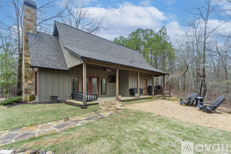 A house with a stone patio and a stone chimney.