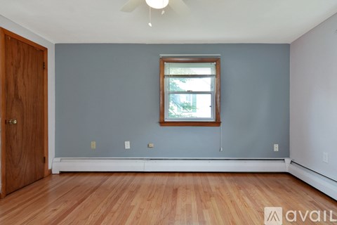 A room with wooden floors and two doors.