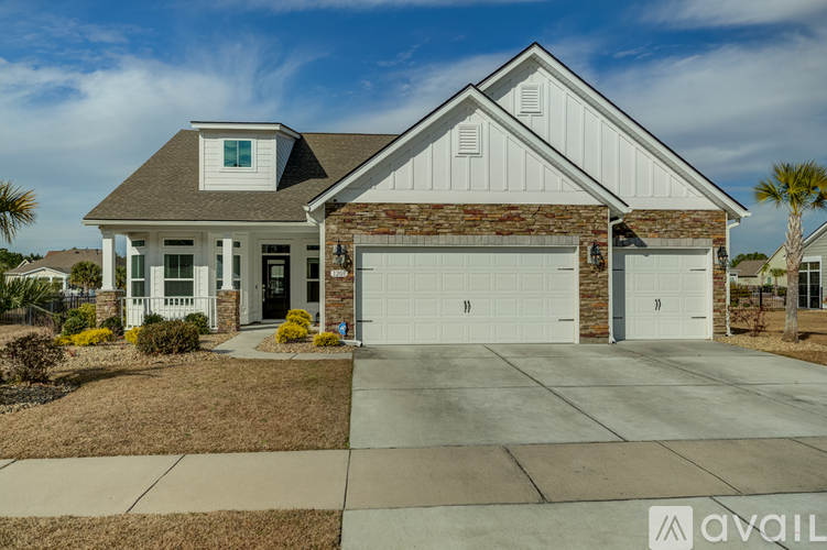A two-story house with a garage is available for sale.