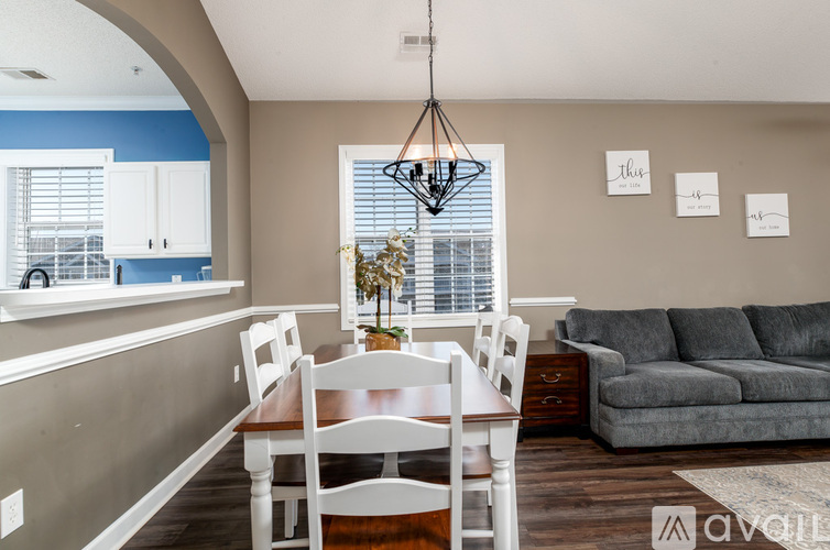 A dining room with a table and chairs.
