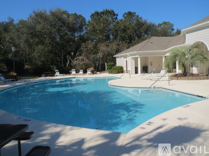 A pool with a house in the background.