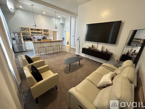 A living room with a large couch and a television.