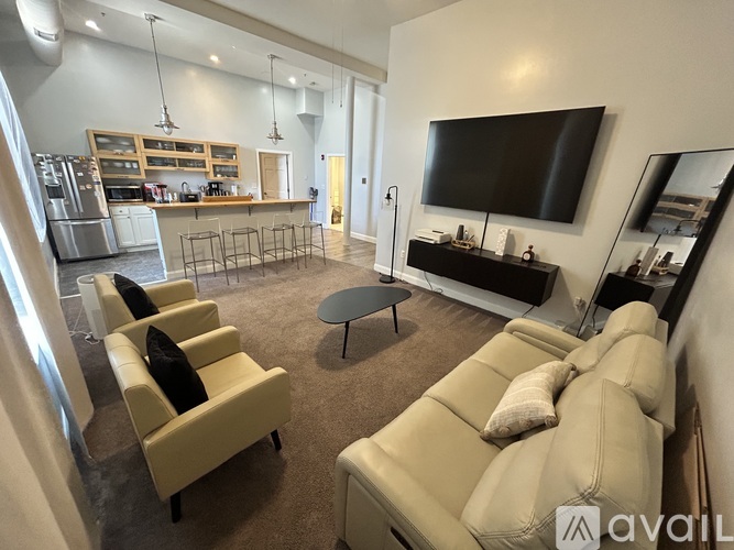 A living room with a television, two couches, and a coffee table.