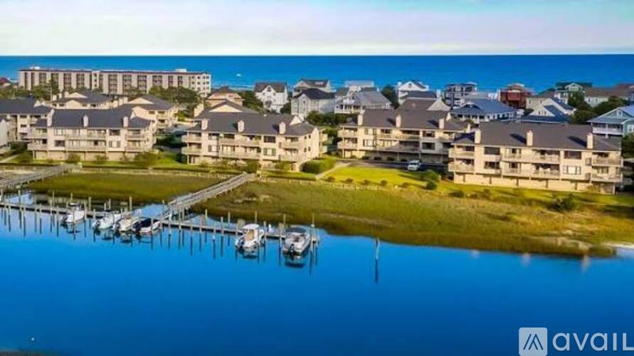 A marina with boats docked in front of apartment buildings.
