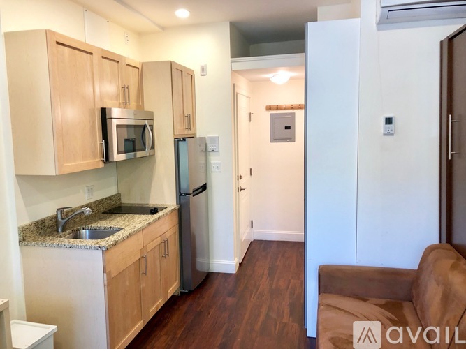 A kitchen with wooden cabinets and a granite countertop.
