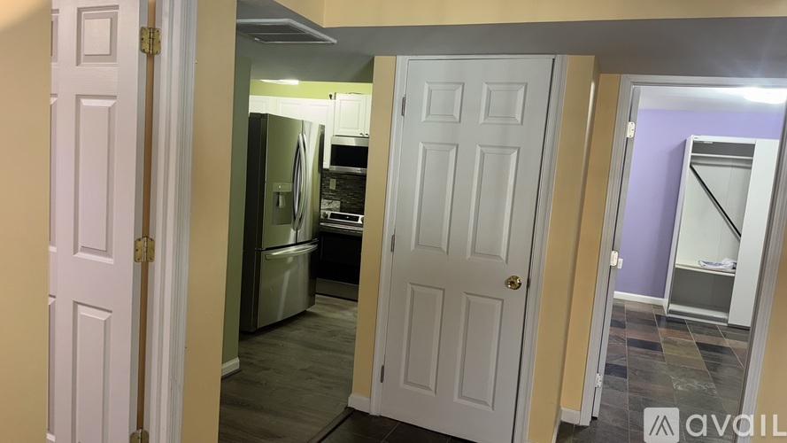 A kitchen with a refrigerator, dishwasher, and oven.