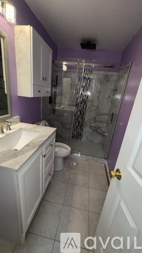 A bathroom with a sink, toilet, and shower.