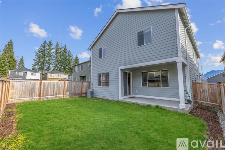 A house with a grey exterior is for sale.