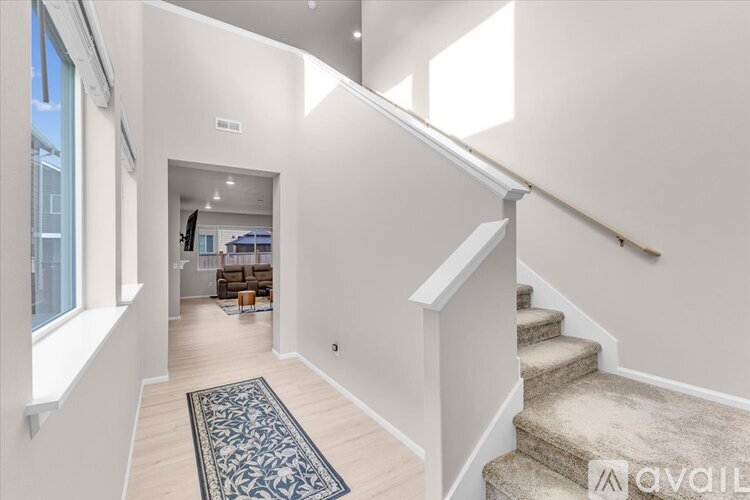 A spacious hallway with a staircase leading to the second floor.